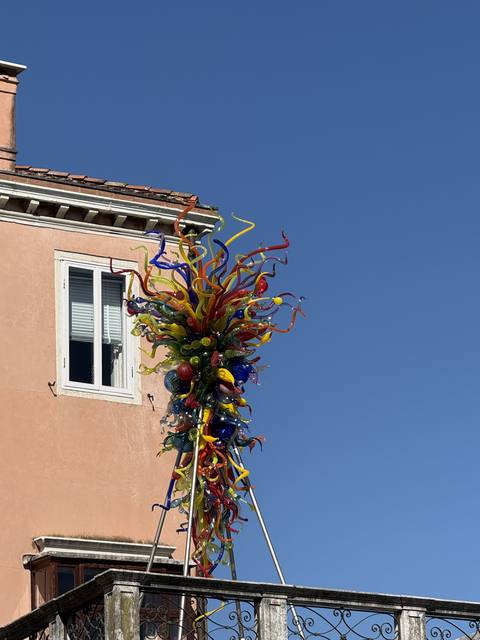 A glass sculpture and a billboard about the exhibition, Venice Biennale